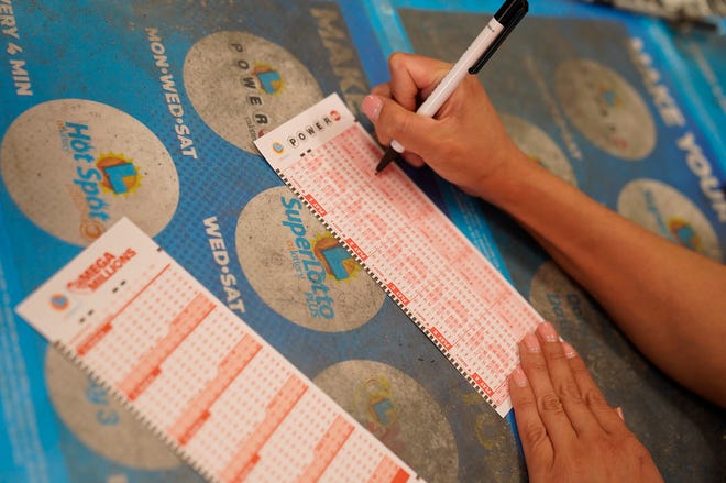 A customer chooses Powerball numbers at Won Won Mini Market liquor store in Los Angeles on Tuesday, July 18, 2023.